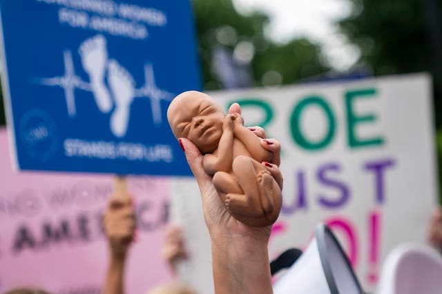 <p>Abortion rights activists and anti-abortion activists rally at the Supreme Court in Washington DC on 21 June </p>