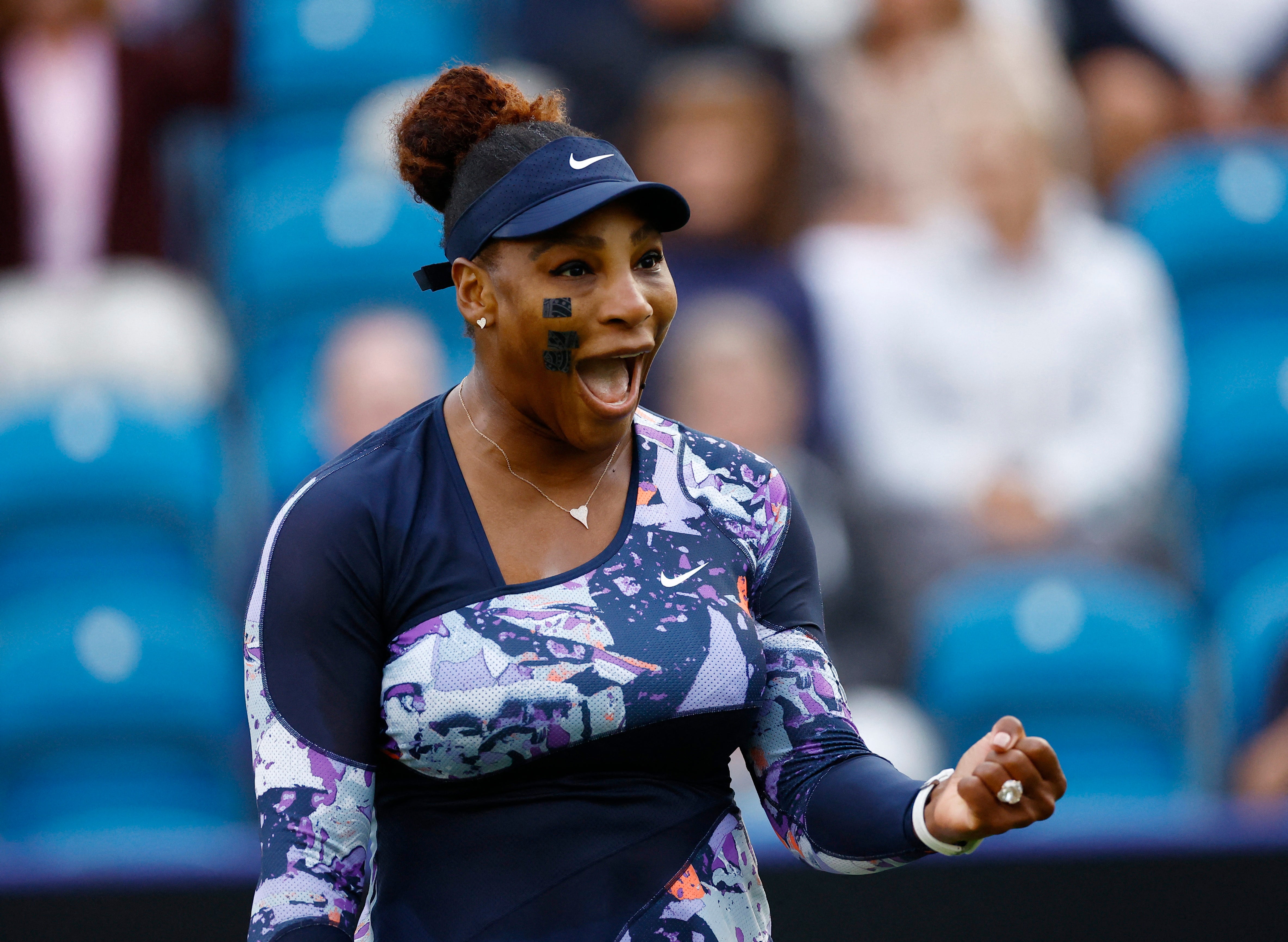 Serena Williams celebrates winning her doubles match with Ons Jabeur