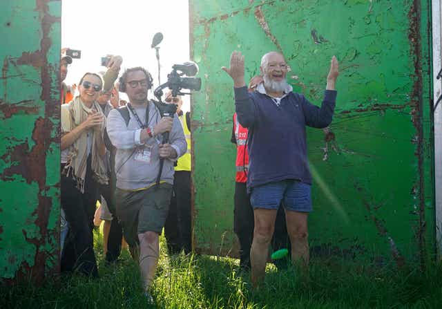 Michael Eavis and his daughter Emily Eavis open the gates on the first day of Glastonbury Festival at Worthy Farm in Somerset (Yui Mok/PA)