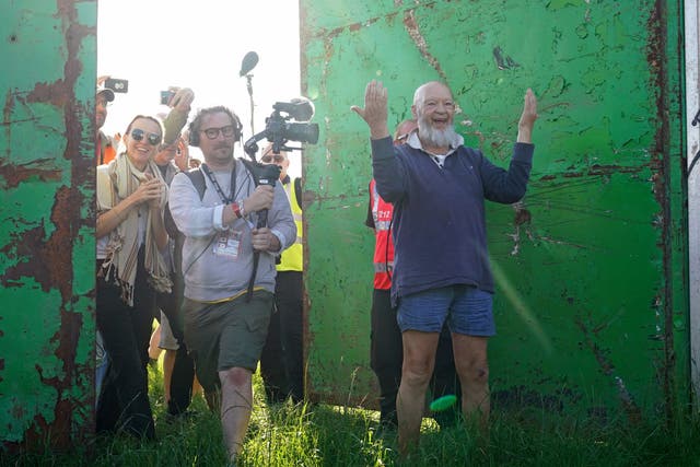 <p>Michael Eavis and his daughter Emily Eavis open the gates on the first day of Glastonbury Festival at Worthy Farm in Somerset (Yui Mok/PA)</p>
