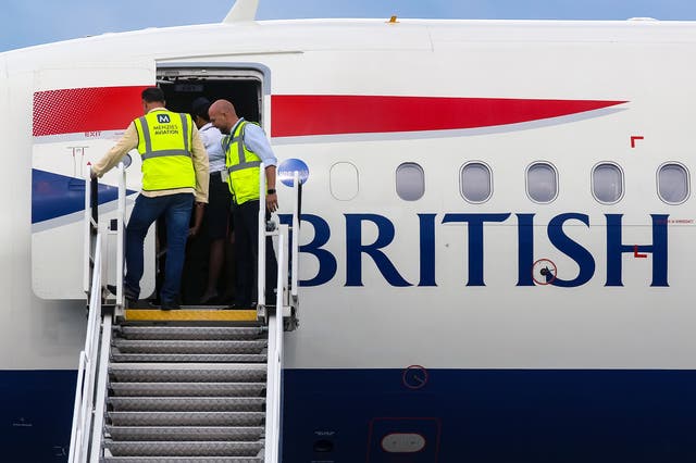 <p>Airport staff board a British Airways plane</p>