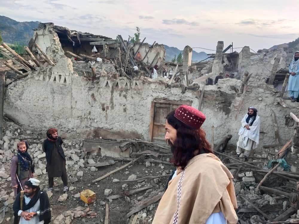Locals look at the destruction caused by an earthquake in eastern Afghanistan