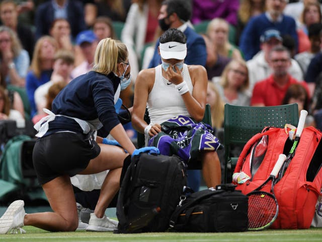 <p>Emma Raducanu receives medical treatment during her match against Ajla Tomljanovic at Wimbledon last year </p>