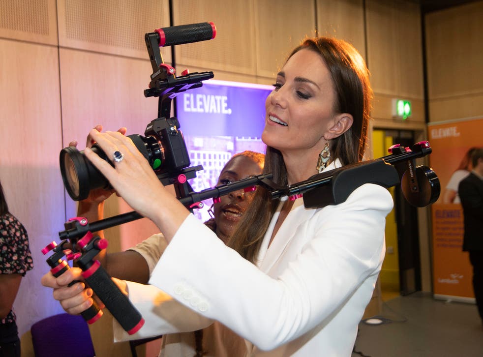 The Duchess of Cambridge holds a camera (Eddie Mulholland/PA)