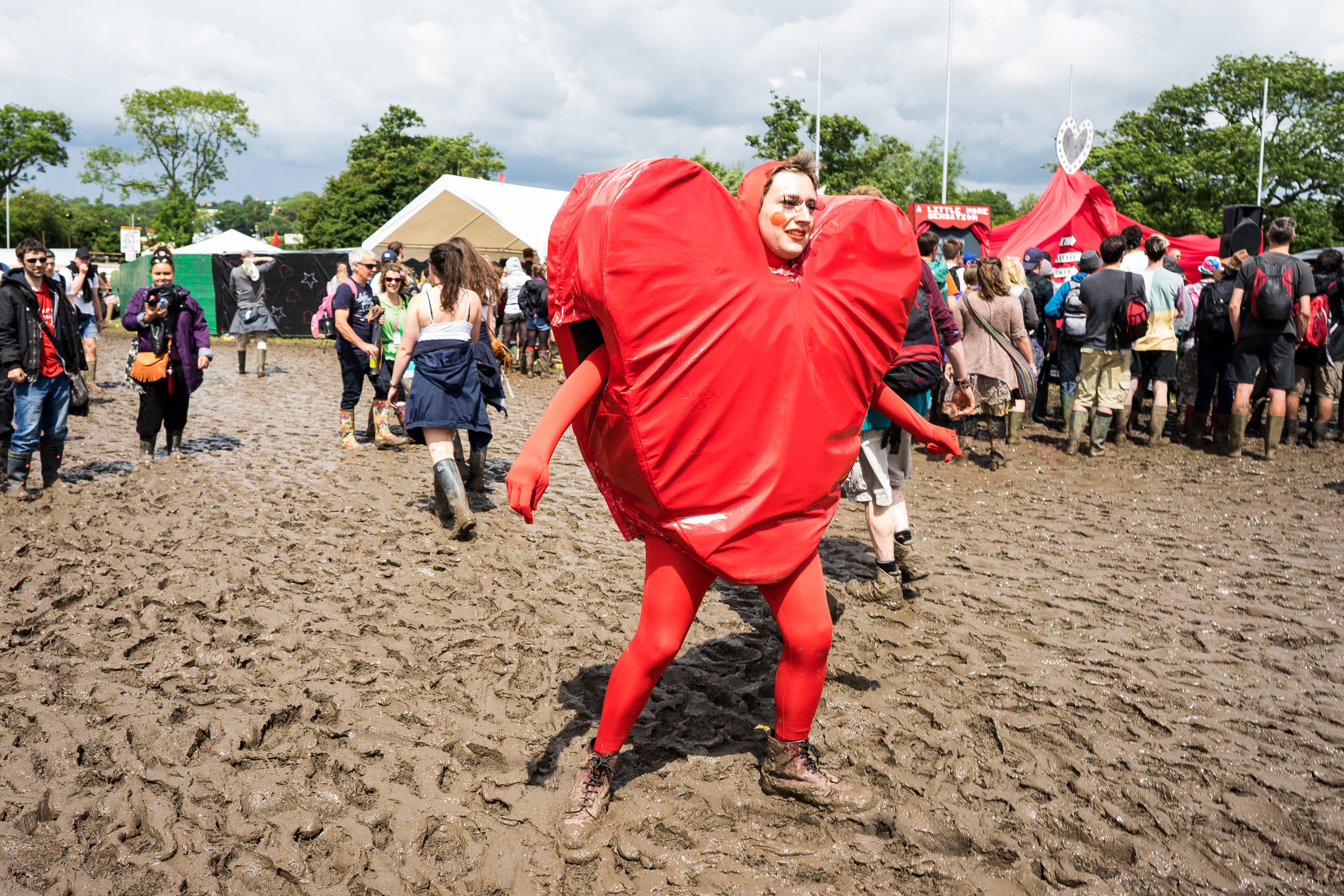 An actor wears a heart-shaped costume in the circus area in 2016