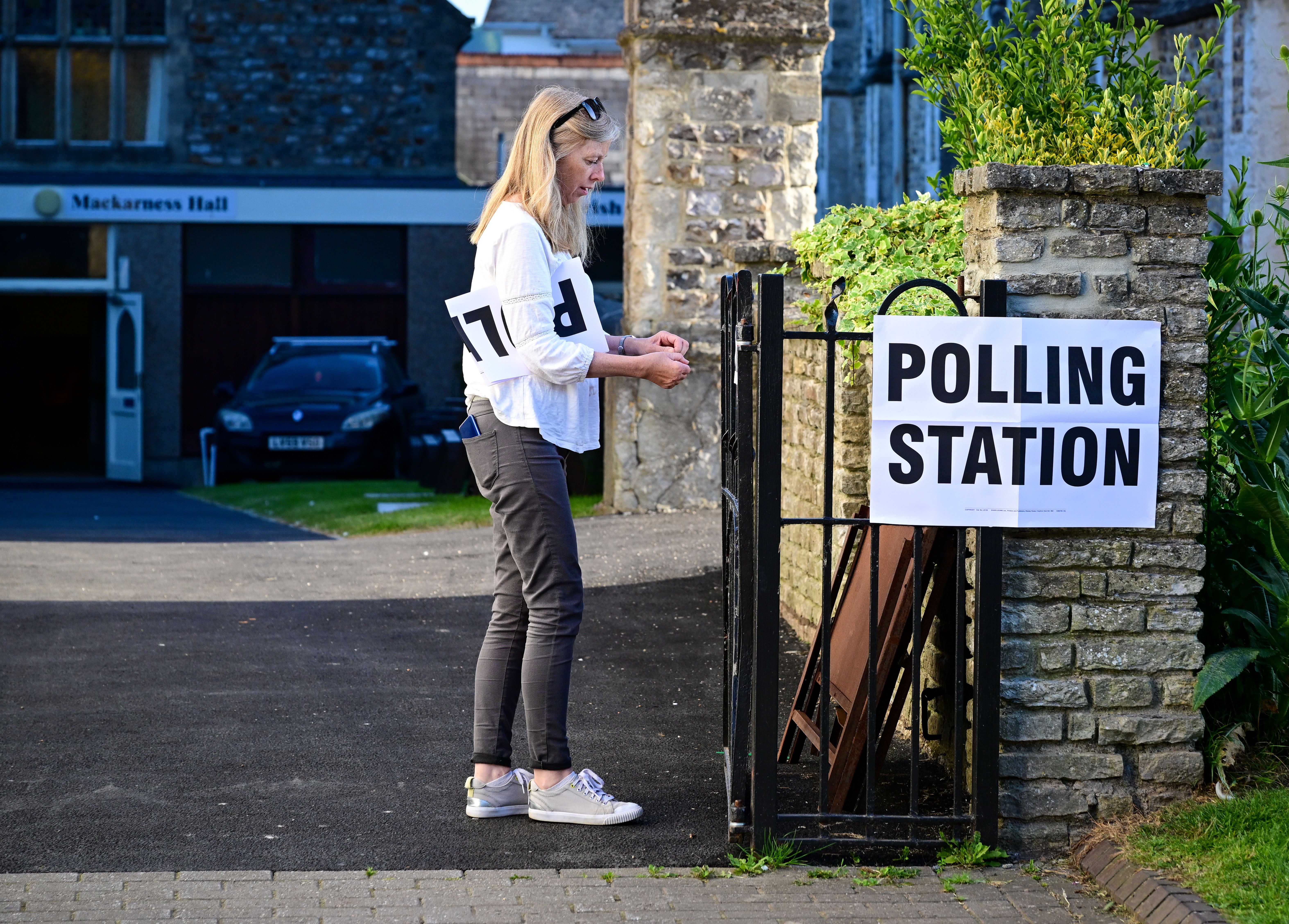 Signs are put up at a polling station in the Tiverton and Honiton by-election