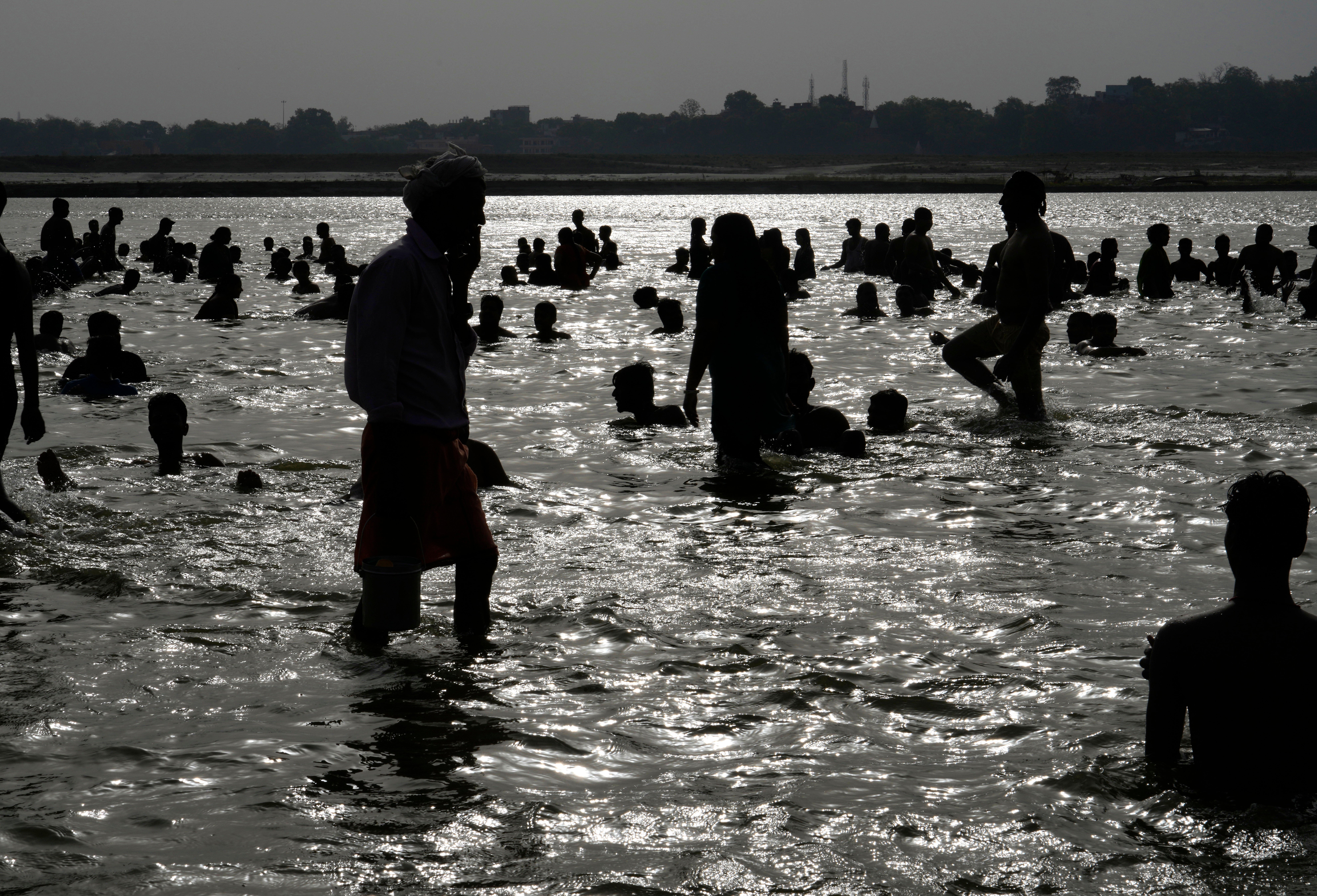 <p>People bathe in the river Ganges to cool themselves off as northern Indian continues to reel under intense heat wave in Prayagraj, Uttar Pradesh</p>