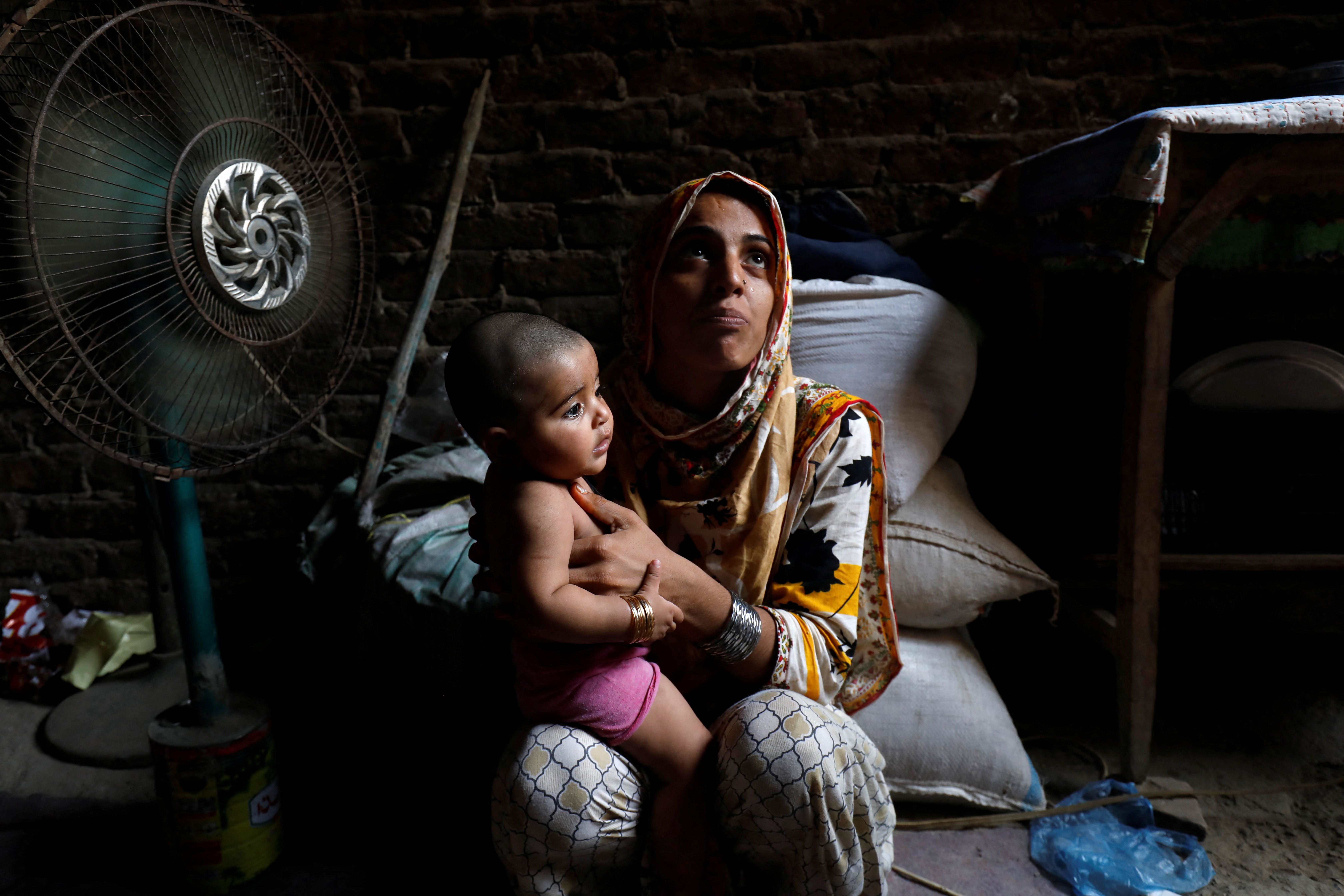 Razia, 25, and her six-month-old daughter Tamanna cool off during a heatwave in Jacobabad, Pakistan