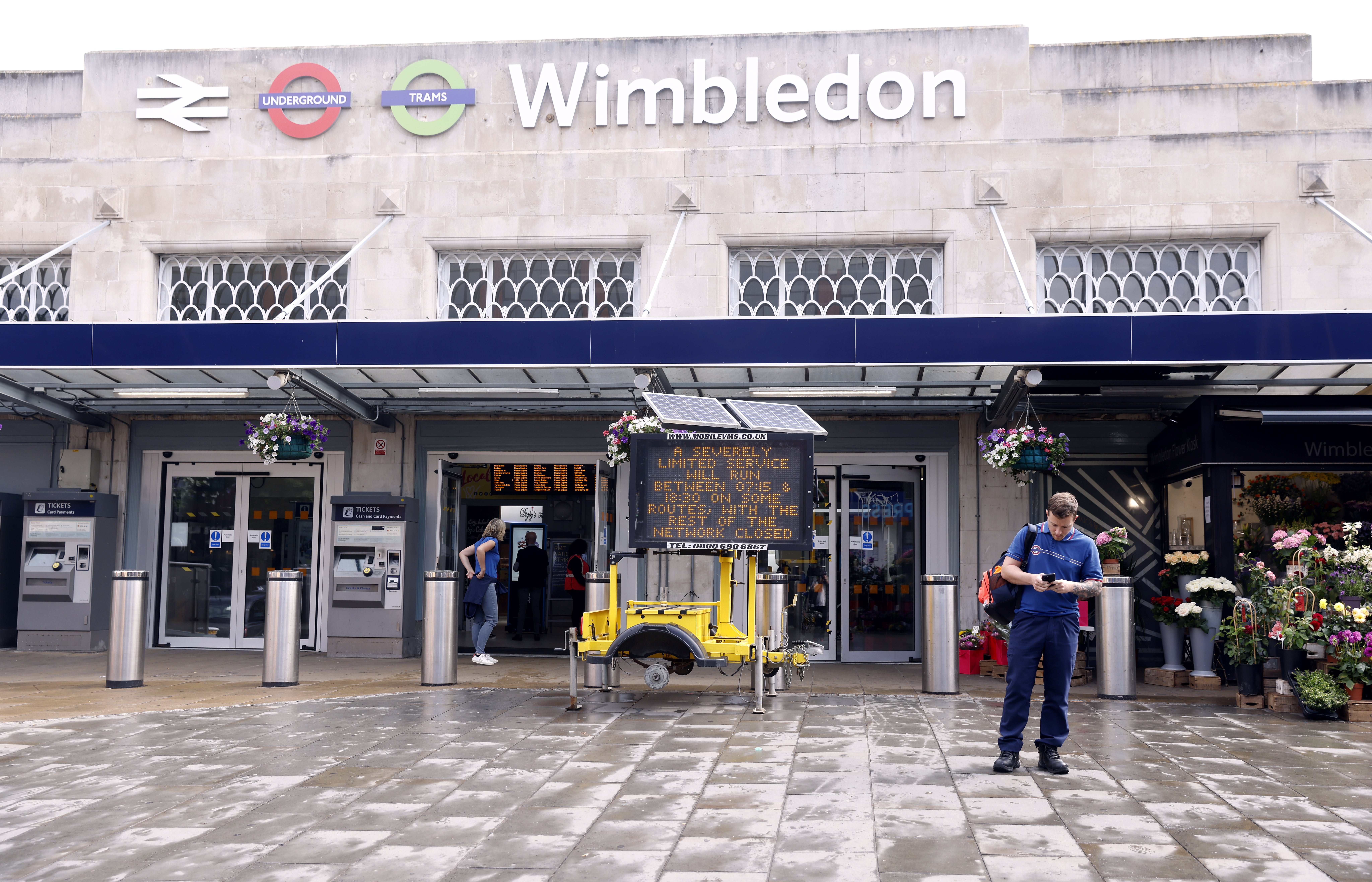 Signage warning of limited services outside Wimbledon station (Steven Paston/PA)