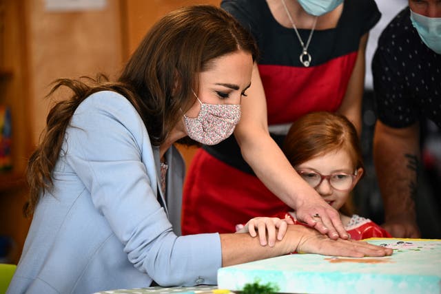 The Duchess of Cambridge puts a hand print on a canvas next to Willow Bamber during a visit to East Anglia’s Children’s Hospices (EACH) in Milton (Ben Stansall/PA)
