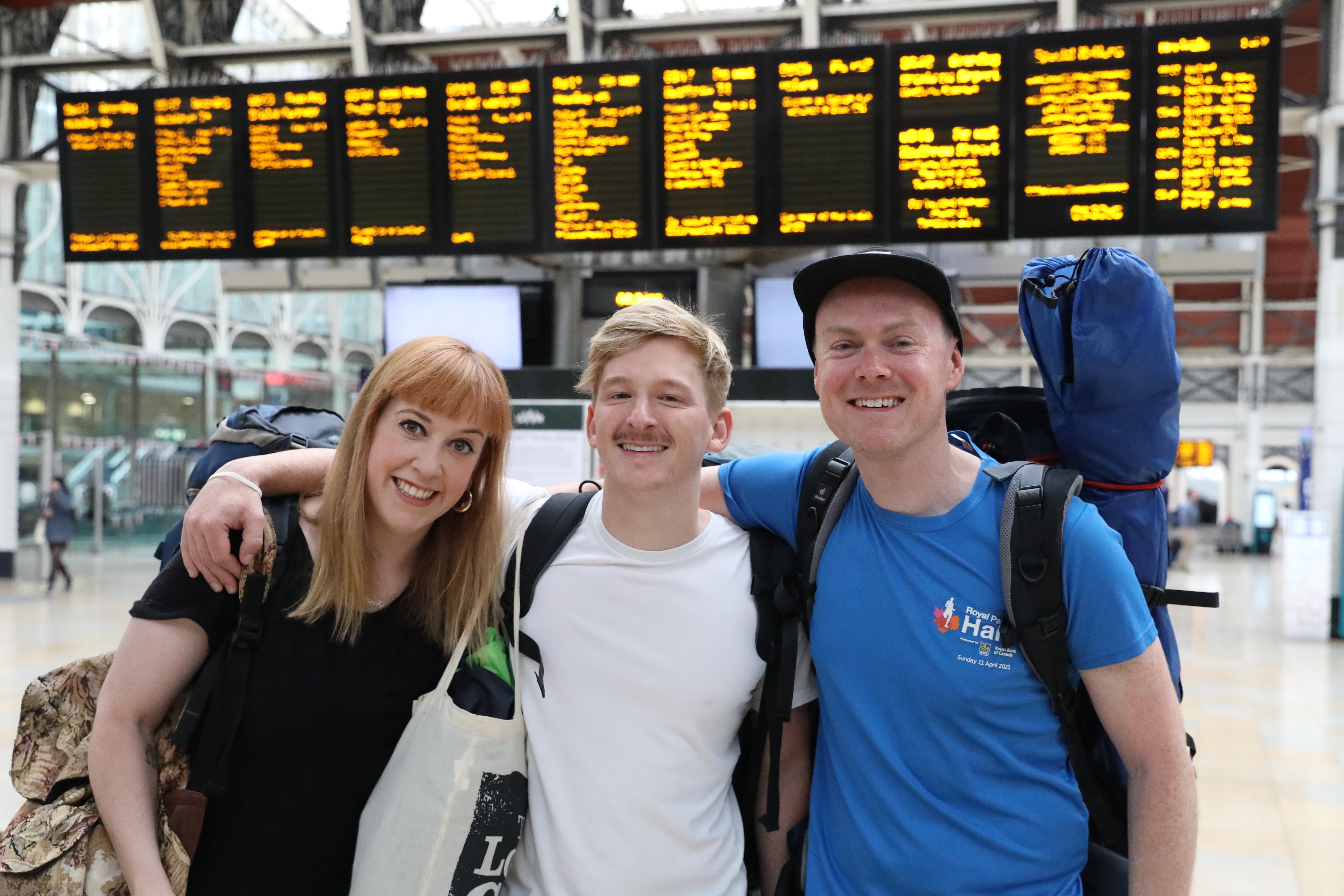 From left: Becky Moriarty, Jared Hill and Rory Leighton at Paddington Station in London, on their way to Glastonbury (Ashlee Ruggels/PA)