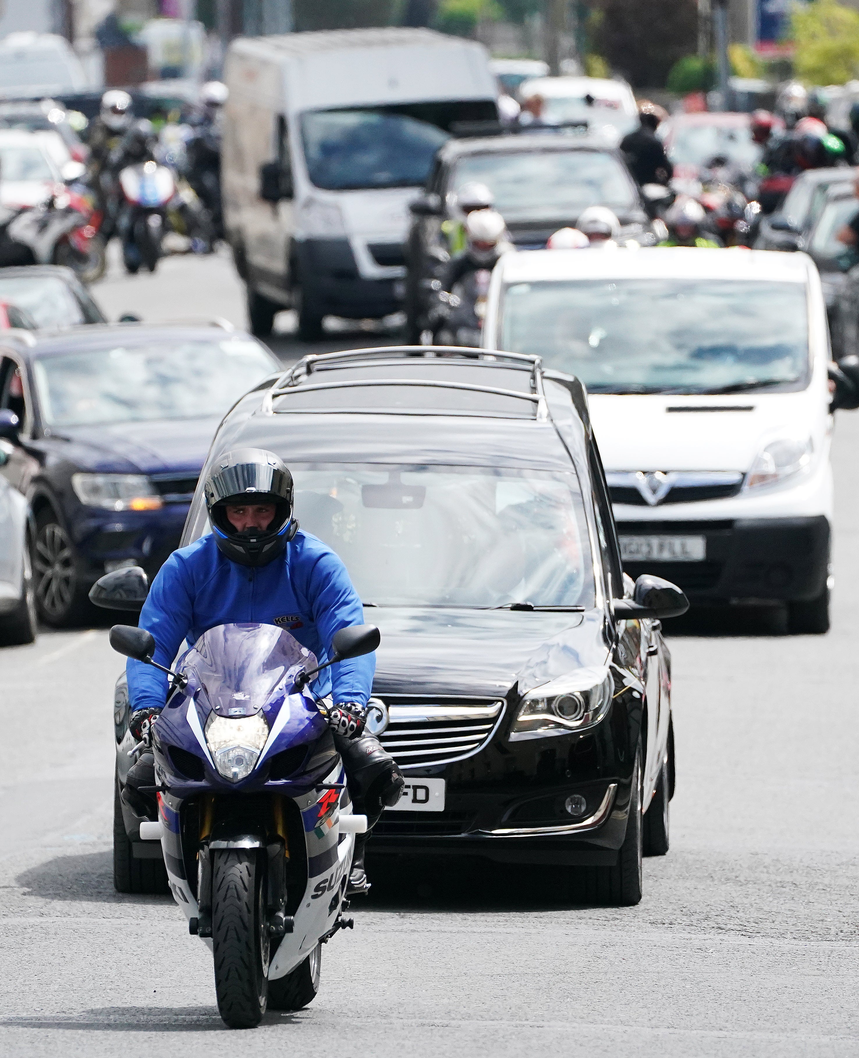 The hearse carrying the remains of Northern Irish rider Jack Oliver, along with a motorcycle escort (Brian Lawless/PA)
