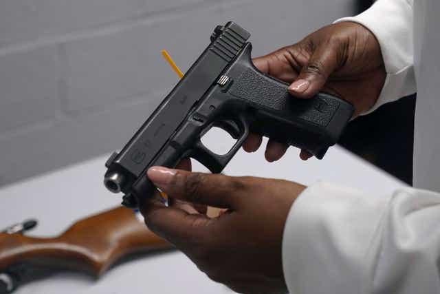 <p>A handgun is viewed during a gun buyback event </p>