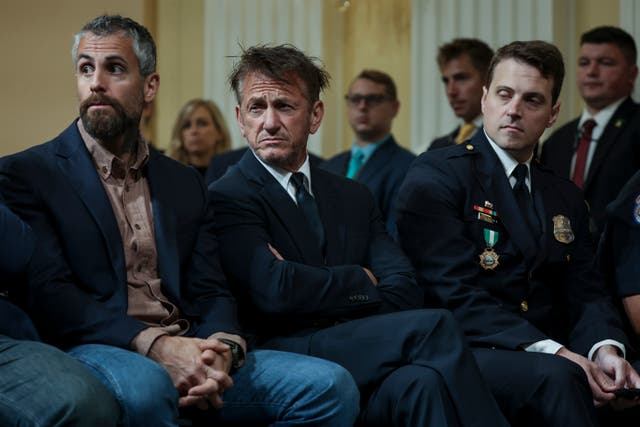 <p>Actor Sean Penn (C) sits with Washington Metropolitan Police Officer Daniel Hodges (R), and retired Metropolitan Police Officer Michael Fanone during the fifth hearing held by the House Select Committee to Investigate the January 6th Attack on the U.S. Capitol, in the Cannon House Office Building on June 23, 2022</p>