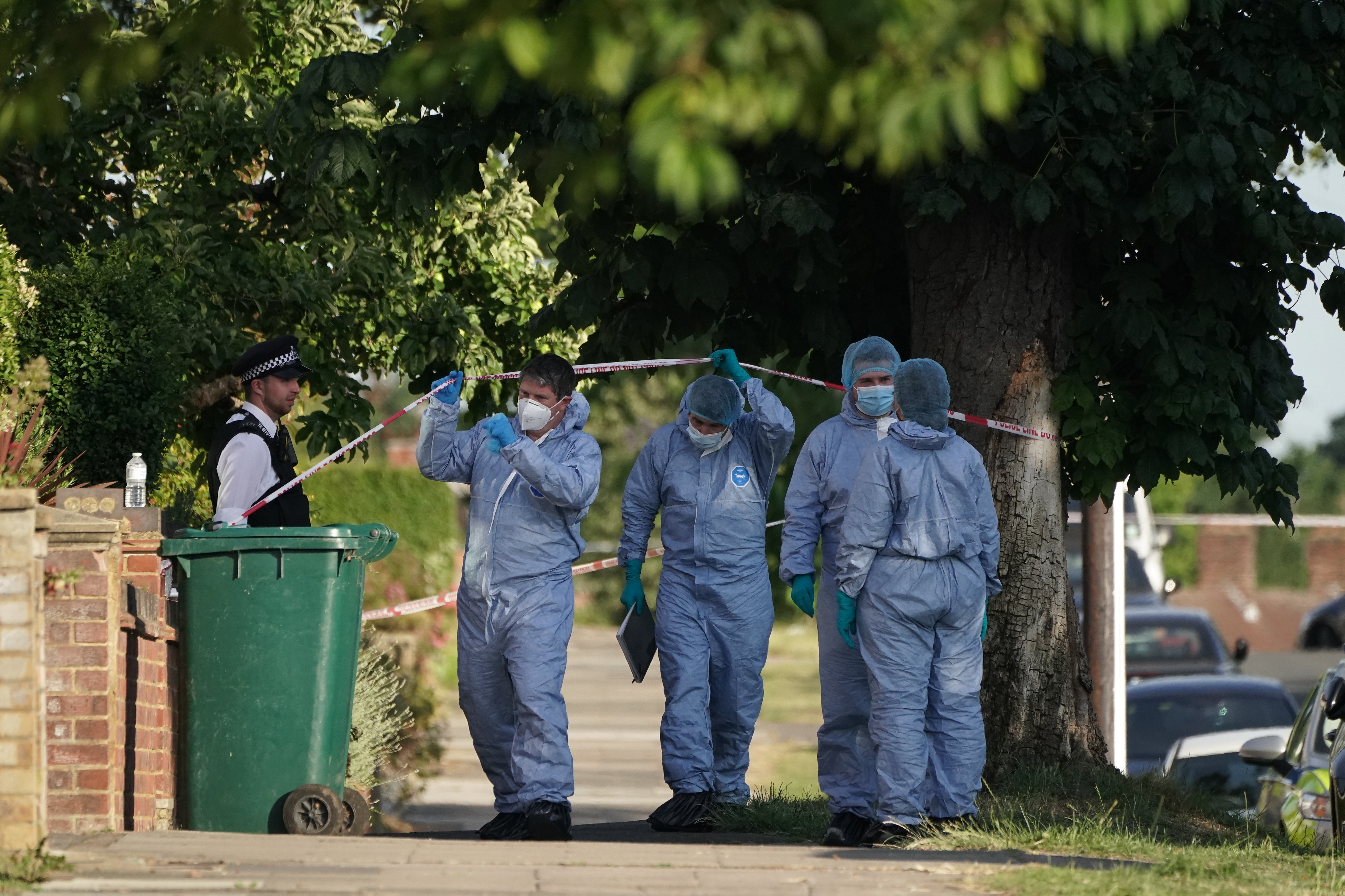 Police investigators at the scene of the incident in north London