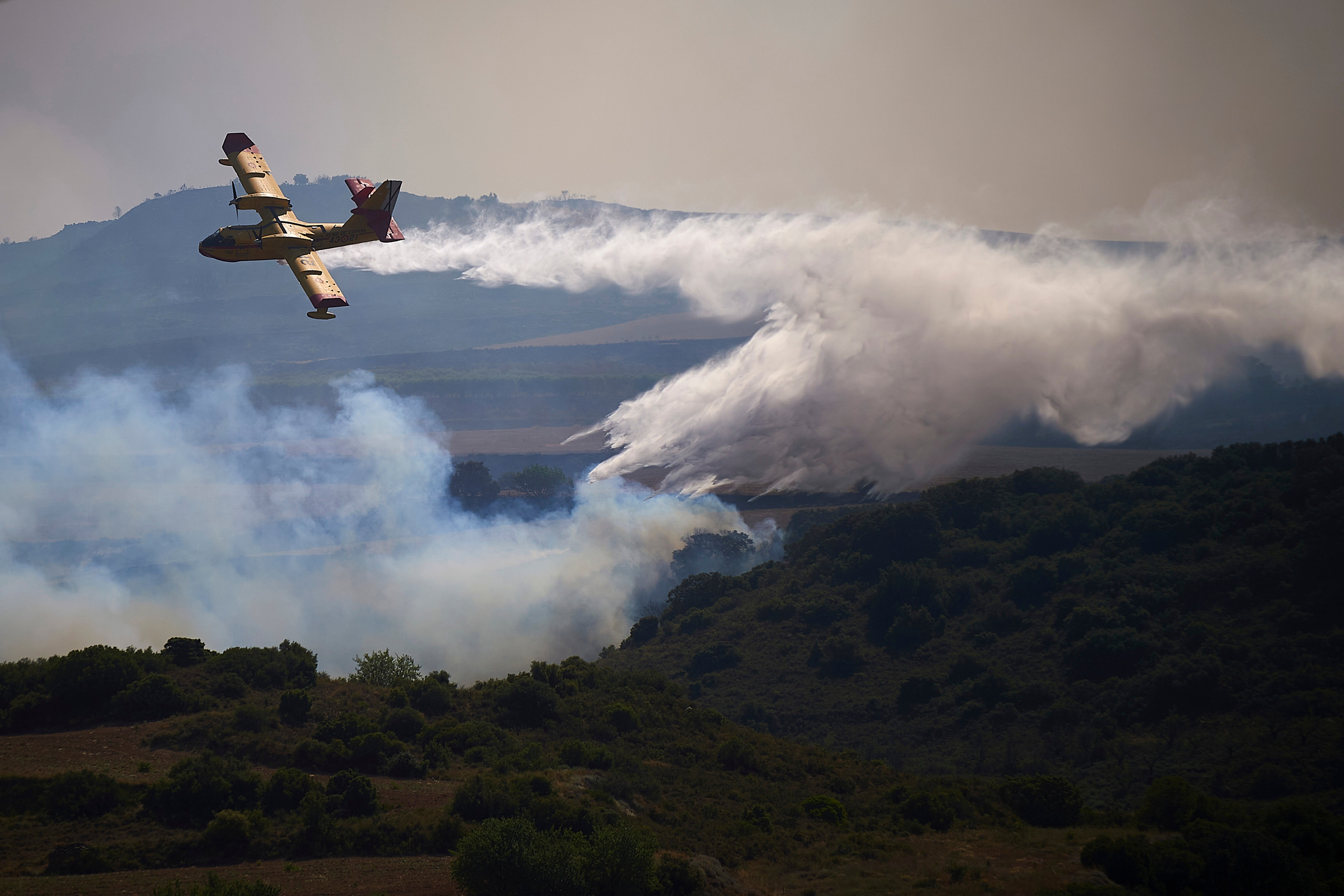 A plane drops a fire retardant on a burning area of San Martin de Unx in northern Spain in June this year