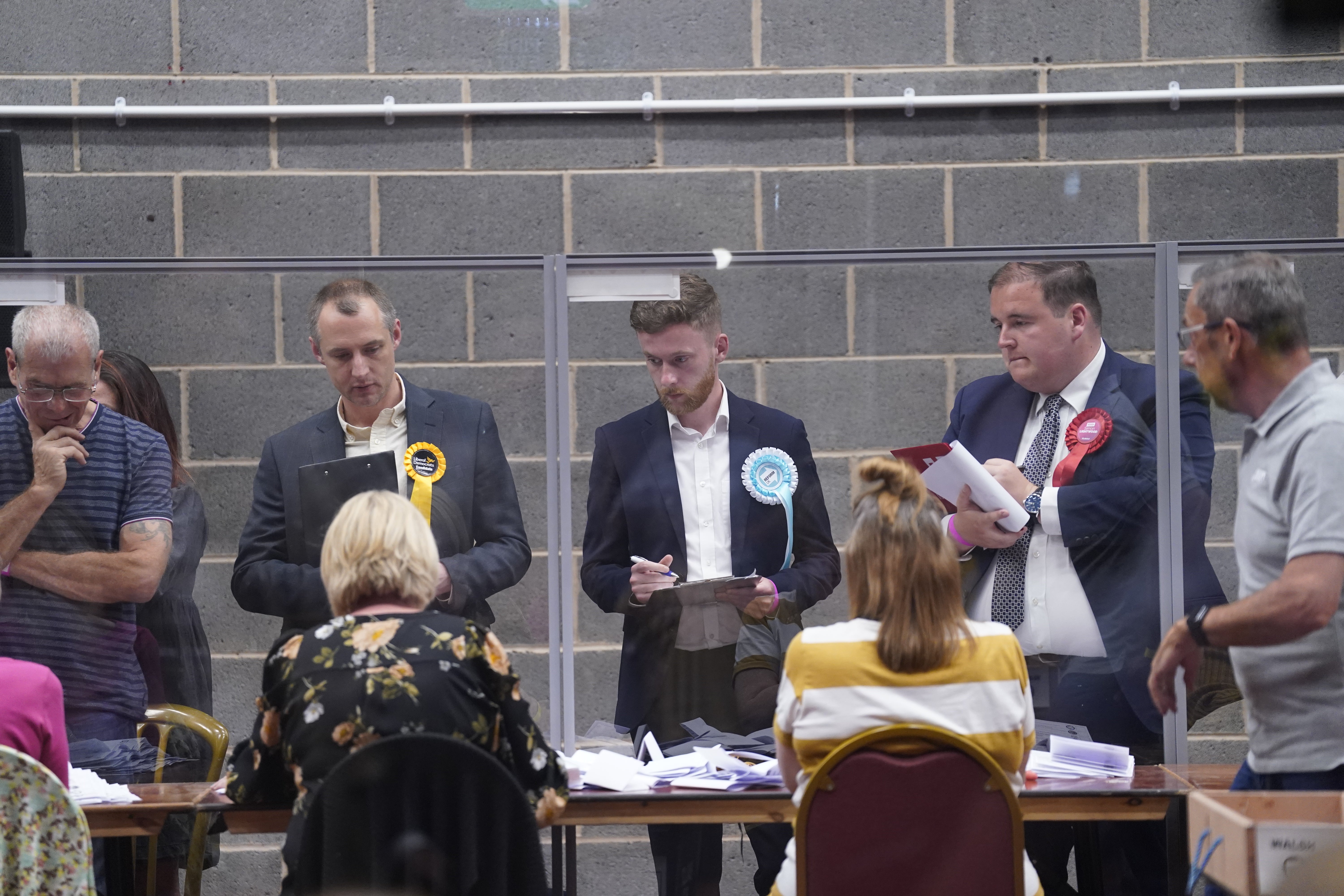 Party officials observe the count at Thornes Park Stadium in Wakefield