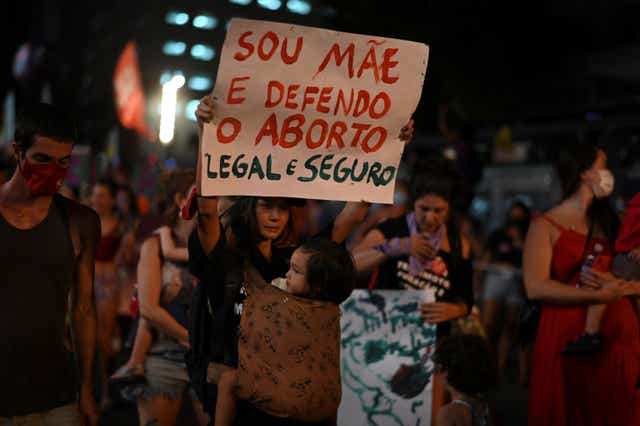 <p>A woman holds a sign in support of legal abortion during a demonstration to commemorate the International Womens Day at the city center of Rio de Janeiro, Brazil</p>