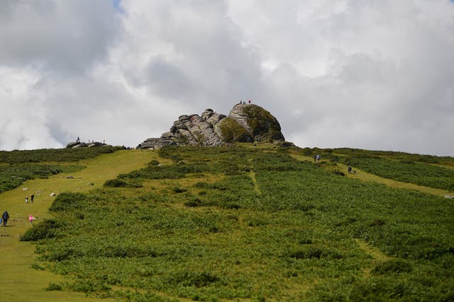 <p>The 22-year-old was watching the sunset at Haytor Rocks (pictured) when he suffered a cardiac arrest</p>