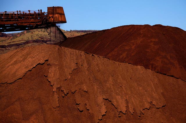 <p>File photo: A stacker unloads iron ore onto a pile at a mine located in the Pilbara region of Western Australia</p>