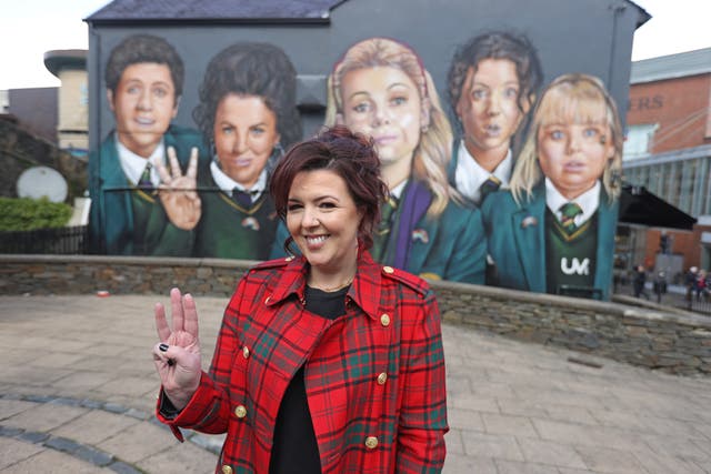Writer Lisa McGee in front of a Derry Girls mural in Londonderry (Liam McBurney/PA)