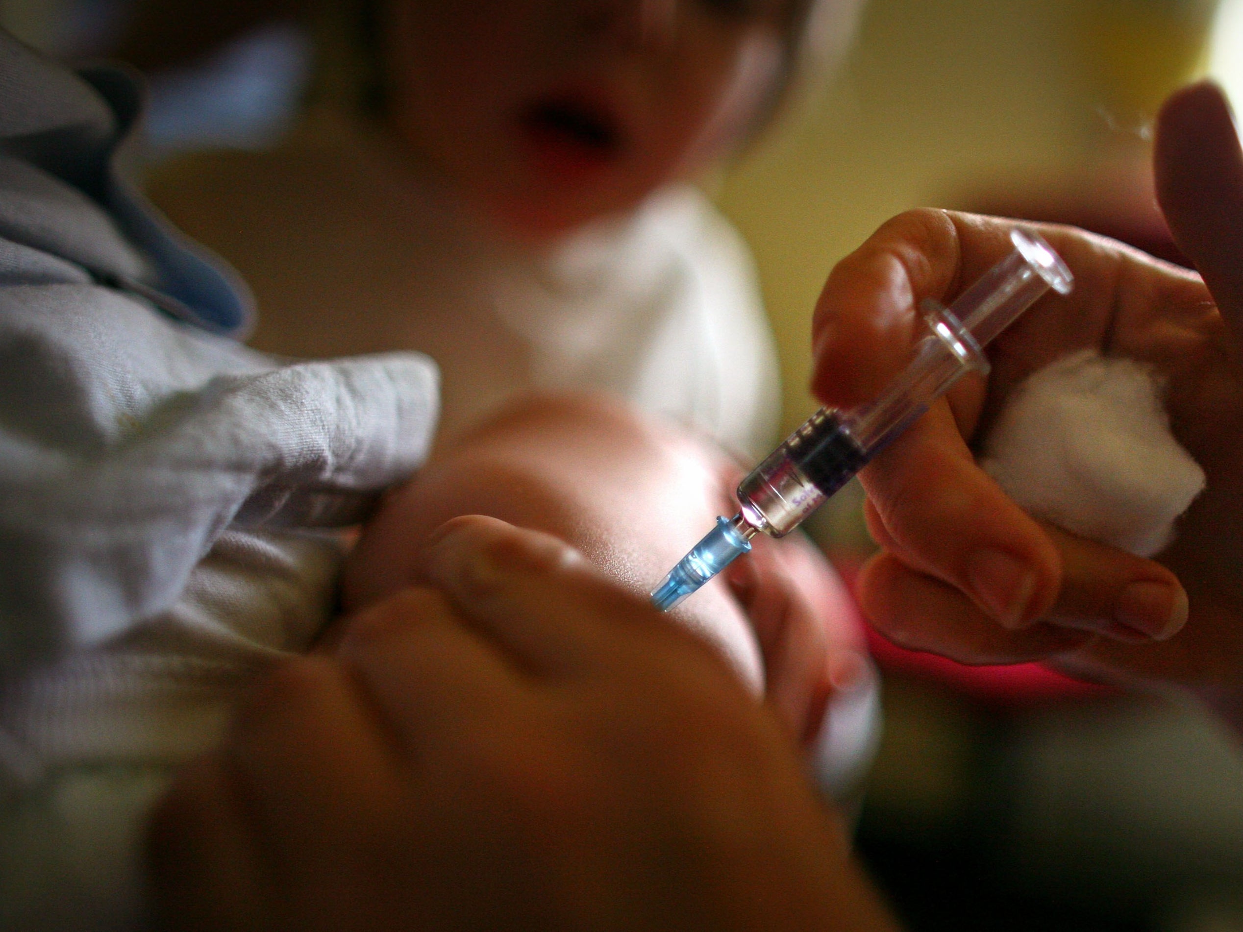 A young boy receives a immunisation jab at a health centre in Glasgow