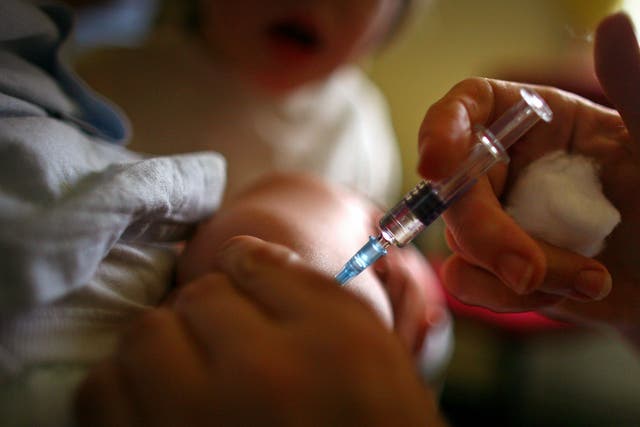 <p>A young boy receives a immunisation jab at a health centre in Glasgow</p>