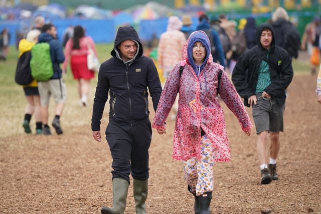 Festivalgoers in the rain during the Glastonbury Festival at Worthy Farm in Somerset (Yui Mok/PA)