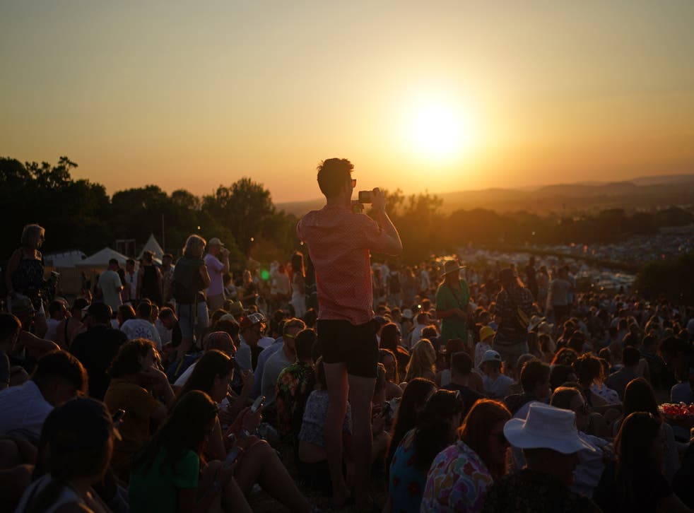 Festivalgoers watch the sunset (PA)