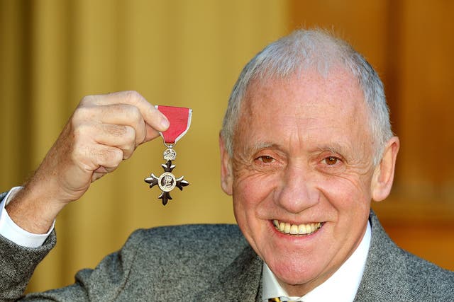 Harry Gration holding his MBE presented to him by the Prince of Wales (John Stillwell/PA)