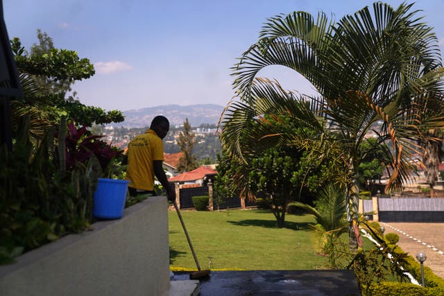 A cleaner in the grounds of the Hope Hostel in Kigali, Rwanda, where migrants will stay after arriving from the UK on a deportation flight (Victoria Jones/PA)