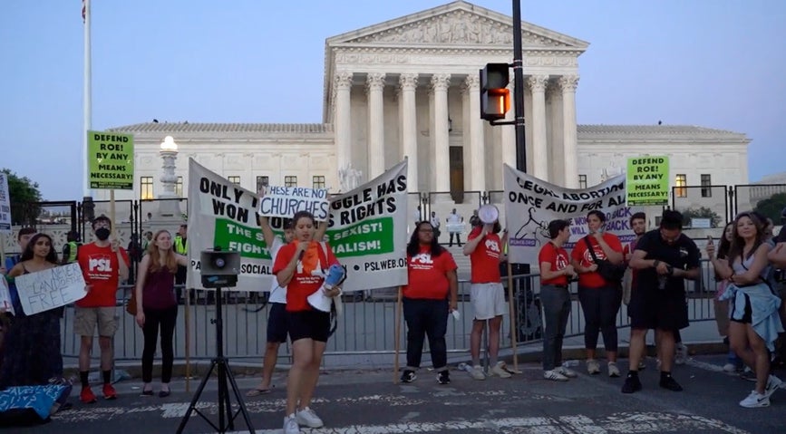 People protest outside the Supreme Court on Friday night