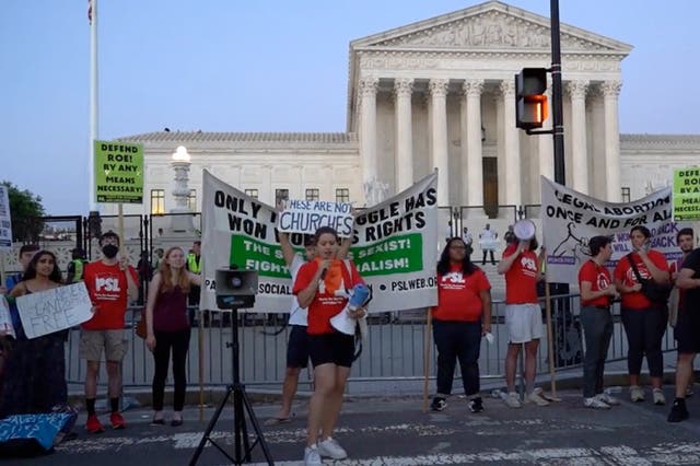 <p>People protest outside the Supreme Court on Friday night</p>