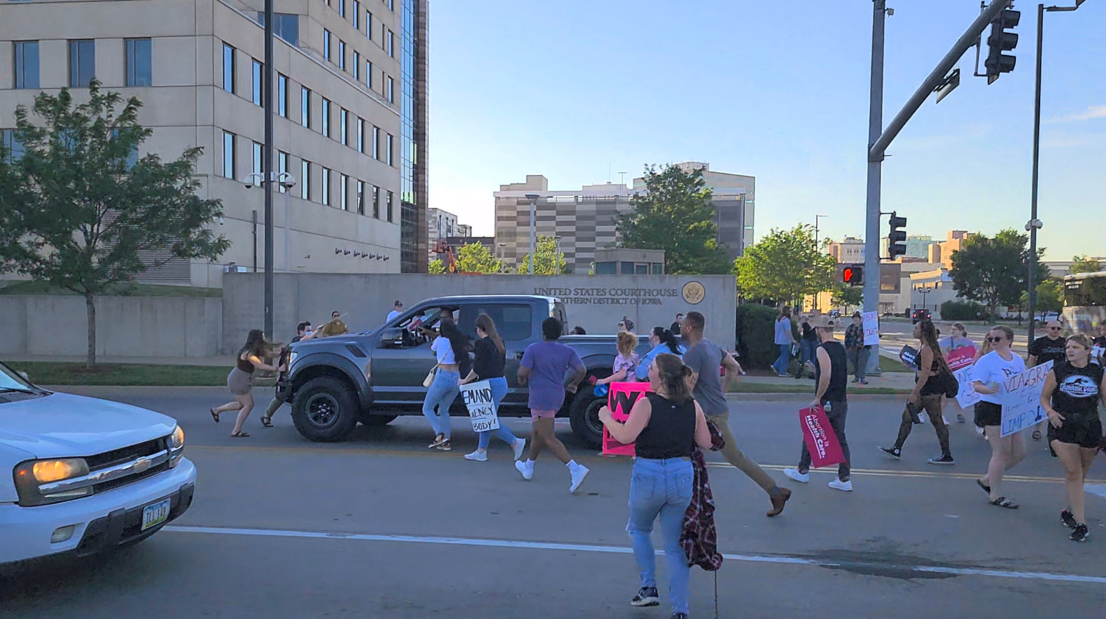 Protesters approach a pickup truck that attempted to run over abortion-rights protesters, in Cedar Rapids, Iowa, US