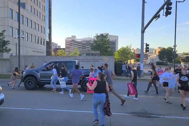 <p>Protesters approach a pickup truck that attempted to run over abortion-rights protesters, in Cedar Rapids, Iowa, US </p>