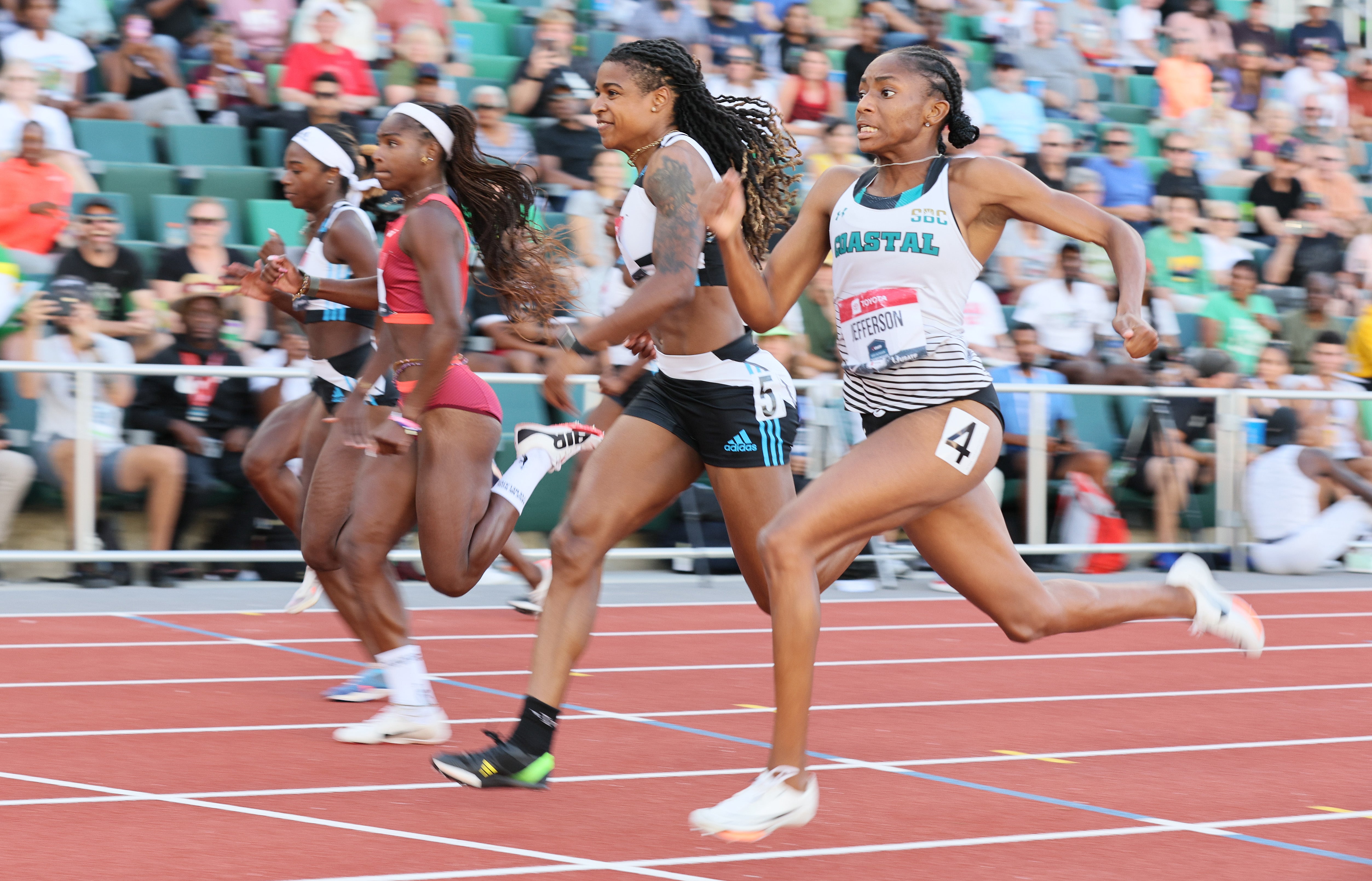 Melissa Jefferson, right, wins the 100m final at the USATF Championships