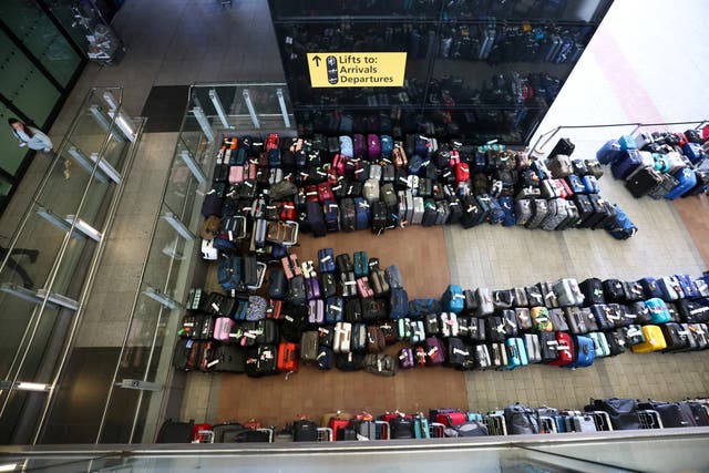 <p>Lines of passenger luggage lie arranged outside Terminal 2 at Heathrow Airport in London</p>