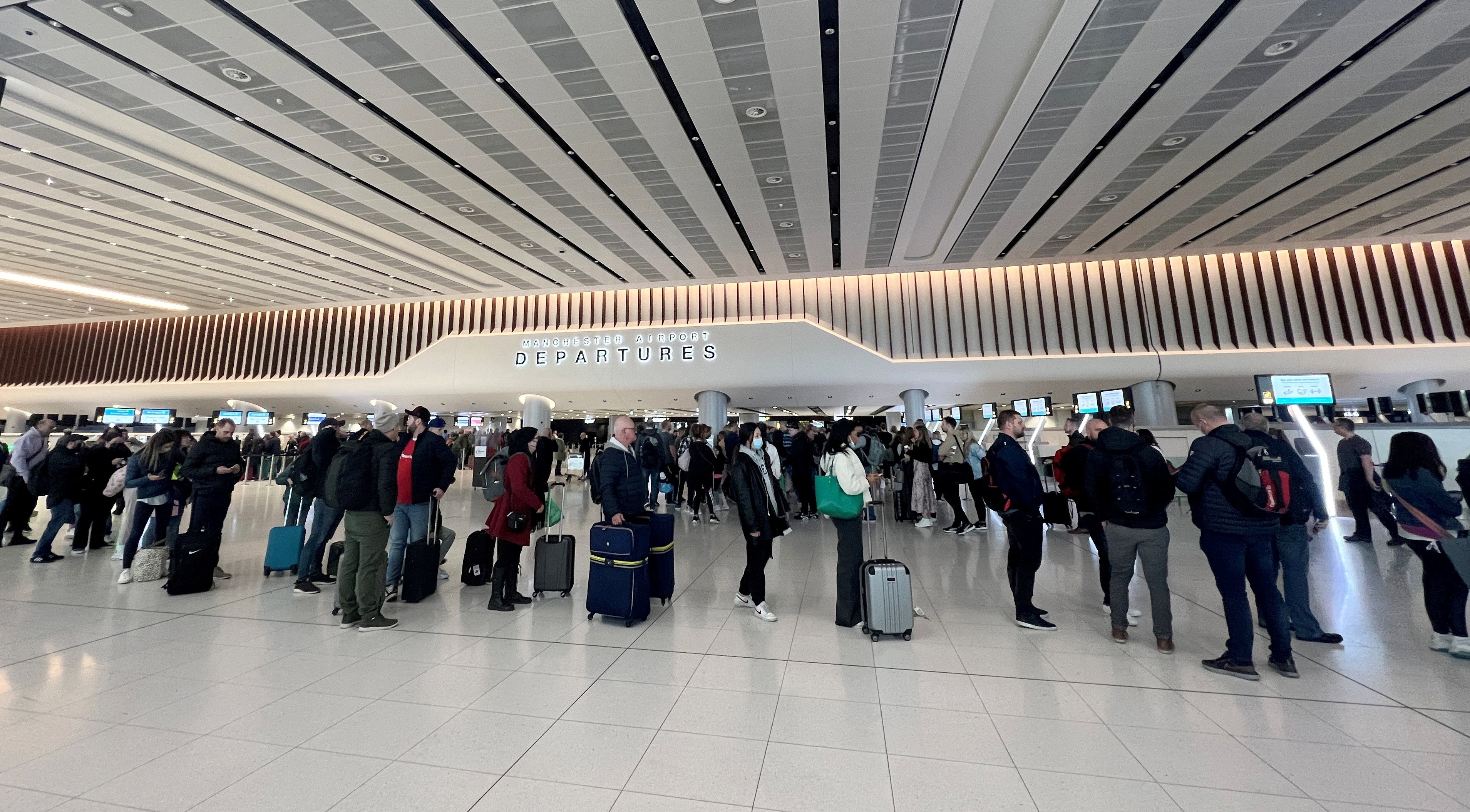 Passengers queue for security screening in the departures area of Terminal 2 at Manchester Airport