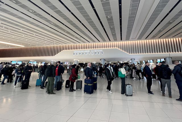 <p>Passengers queue for security screening in the departures area of Terminal 2 at Manchester Airport</p>