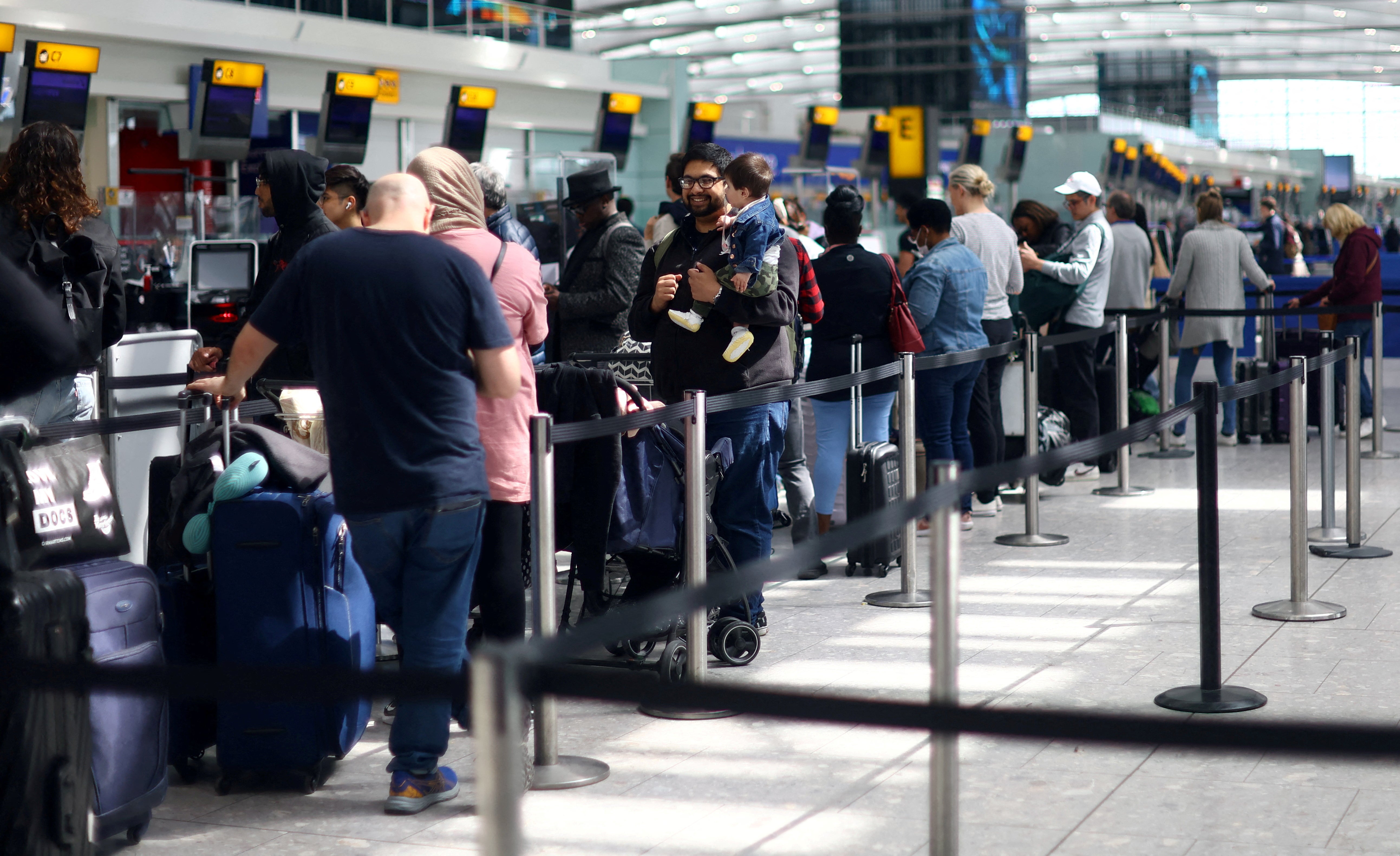 Passengers queue for check-in desks at Heathrow airport’s Terminal 5 in London
