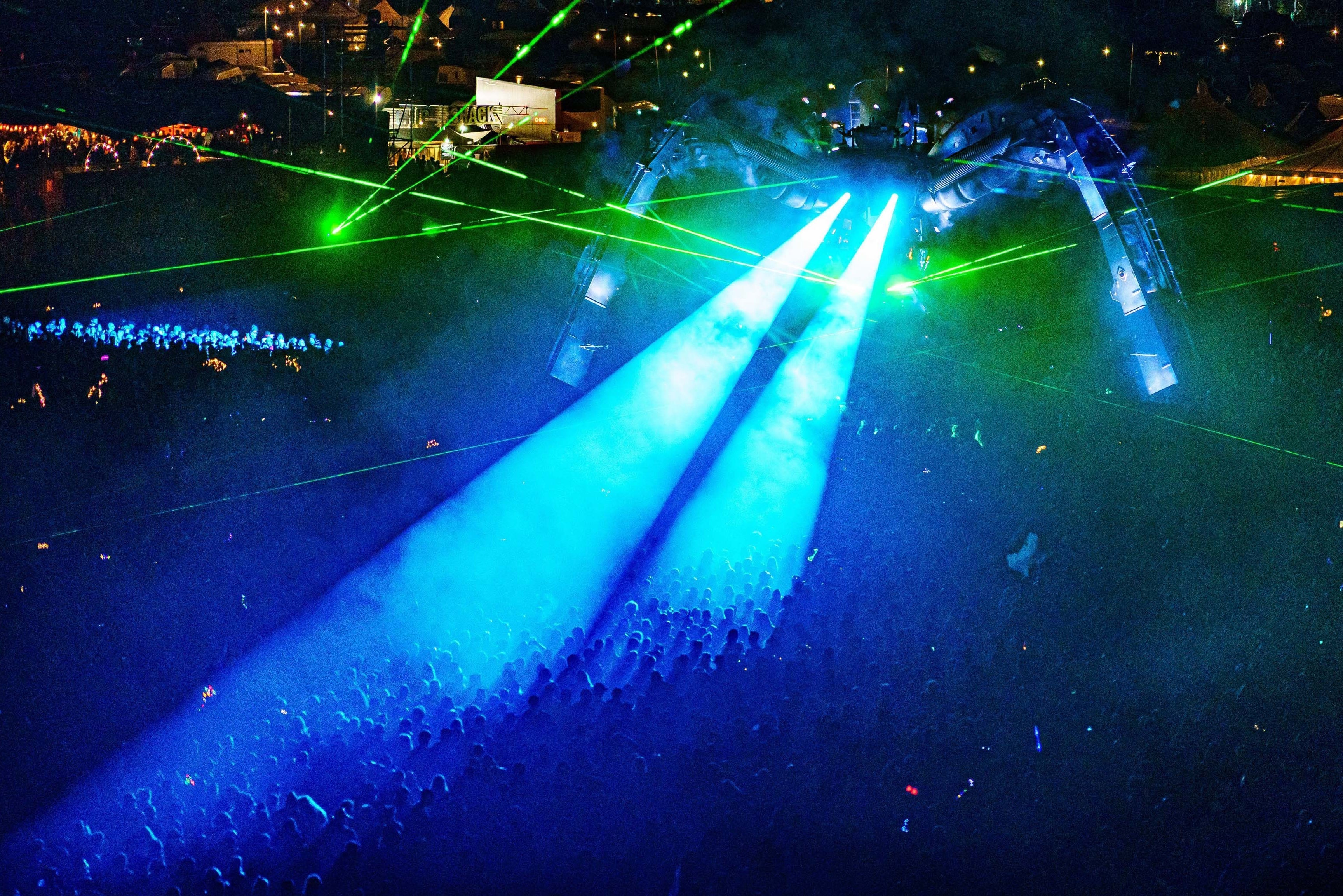 Thousands of revellers watch Groove Armada from beneath a 50-tonne laser spewing and fire breathing spider, at Glastonbury