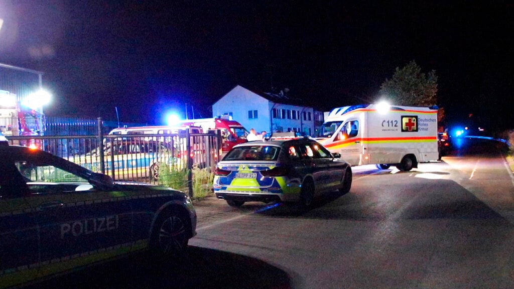 Police and emergency services stand at an asylum seeker shelter after a knife attack in Kressbronn, Germany,