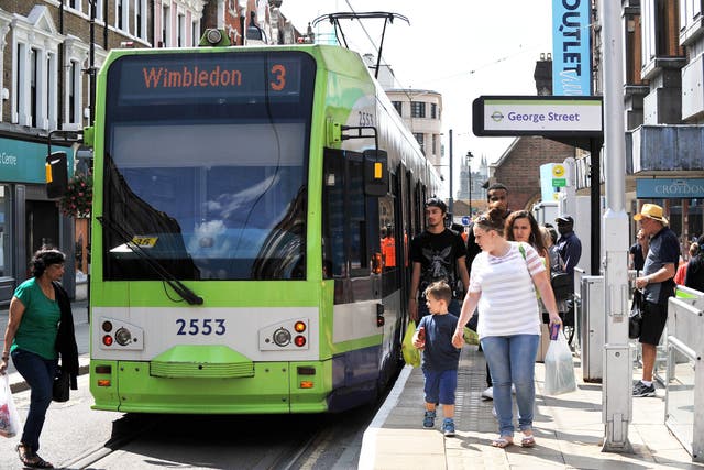 A Tramlink tram waits to leave a tram stop in George Street, Croydon (Nick Ansell/PA)