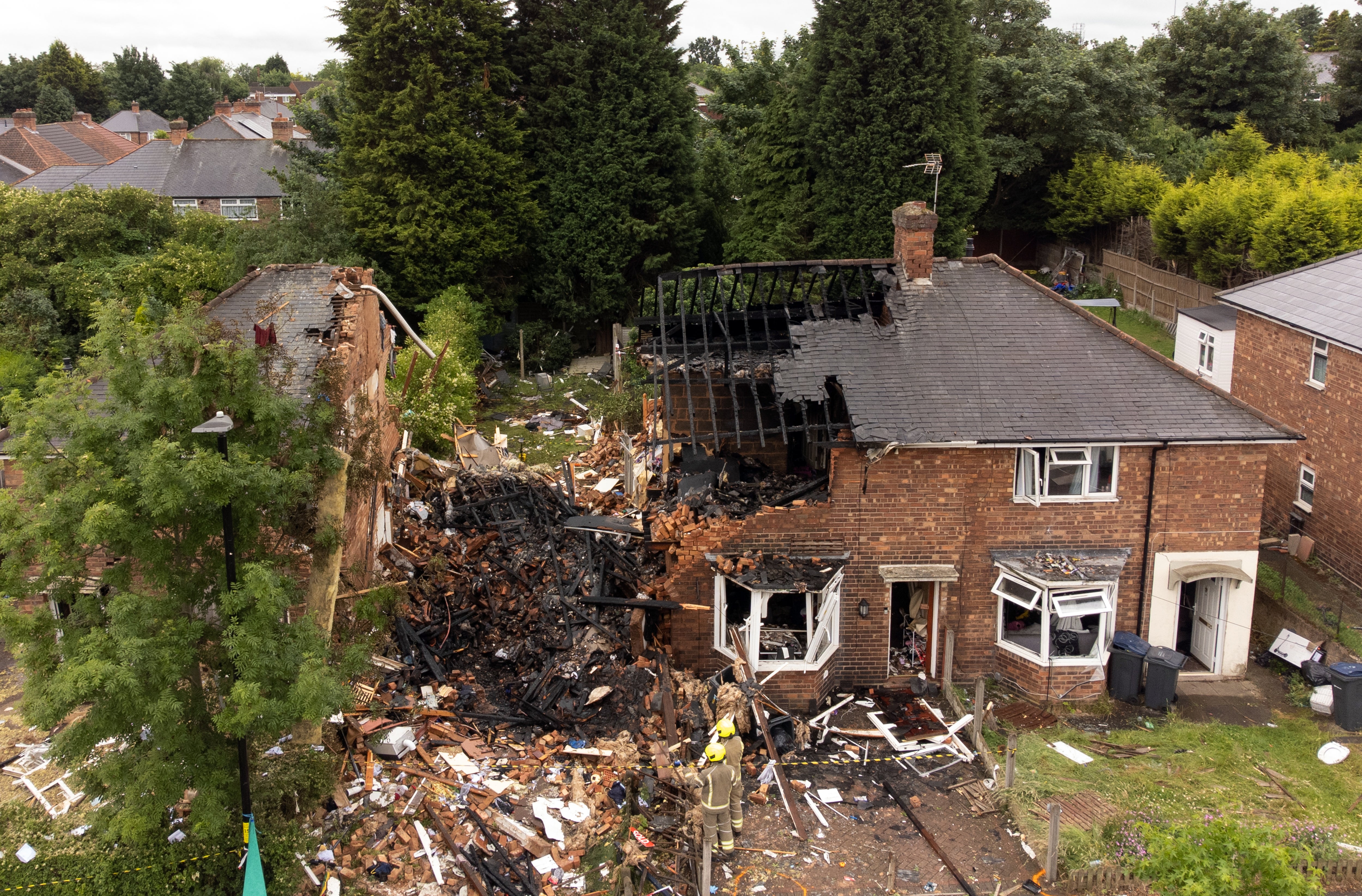 Emergency services at the scene in Dulwich Road, Kingstanding, in Birmingham, where a woman has been found dead after a house was destroyed in a gas explosion. One man rescued from the wreckage remains in hospital in a life-threatening condition. Picture date: Monday June 27, 2022.