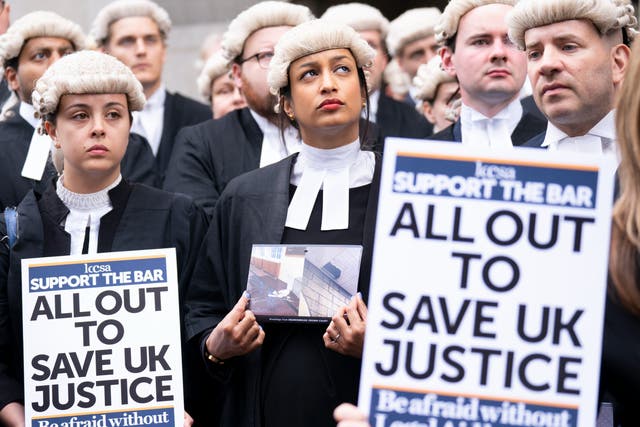 <p>Criminal barristers from the Criminal Bar Association (CBA), which represents barristers in England and Wales,  outside the Old Bailey, central London, on the first of several days of court walkouts by CBA members in a row over legal aid funding</p>