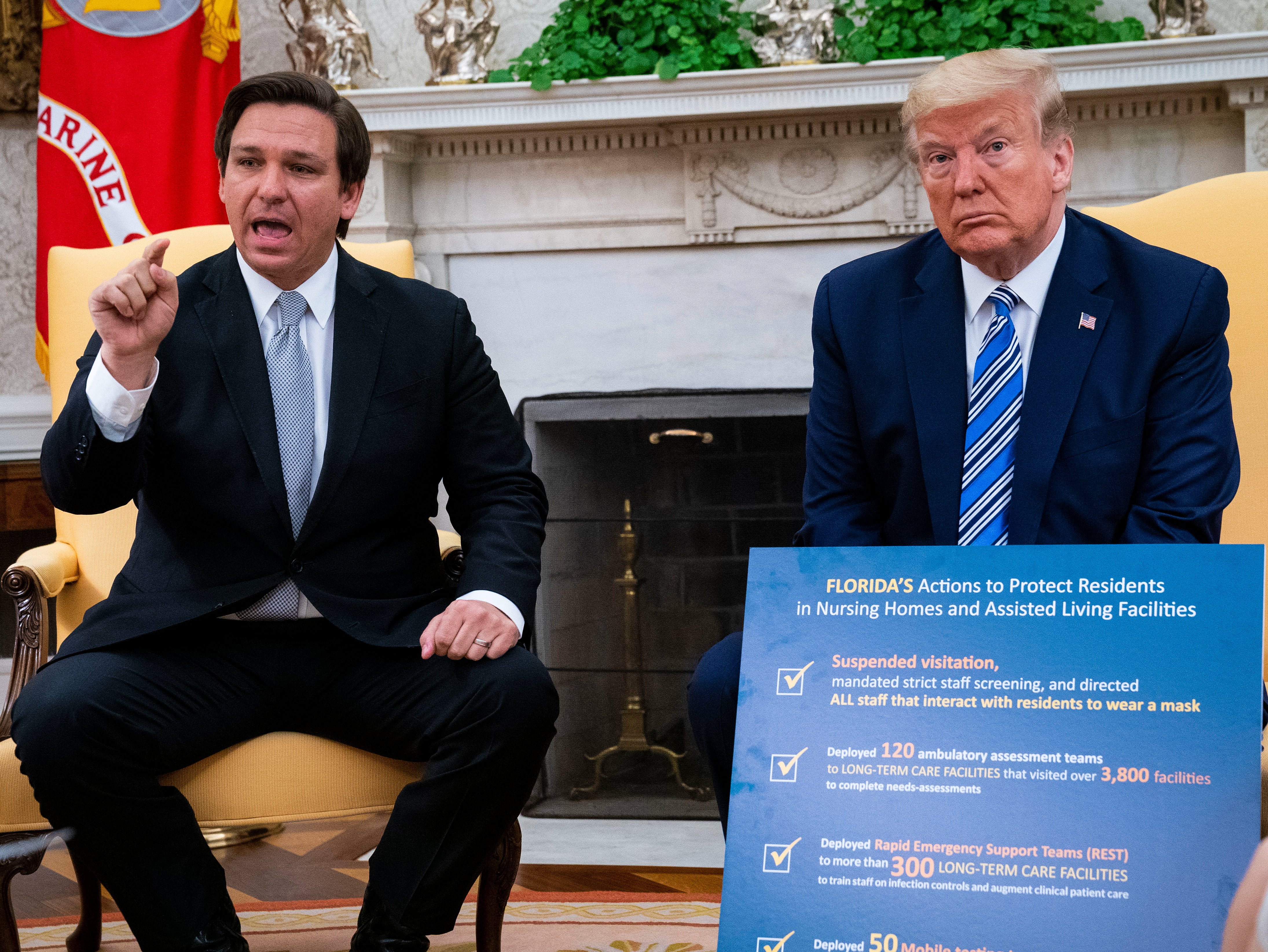 Florida Gov. Ron DeSantis (L) speaks while meeting with U.S. President Donald Trump in the Oval Office of the White House on April 28, 2020 in Washington, DC