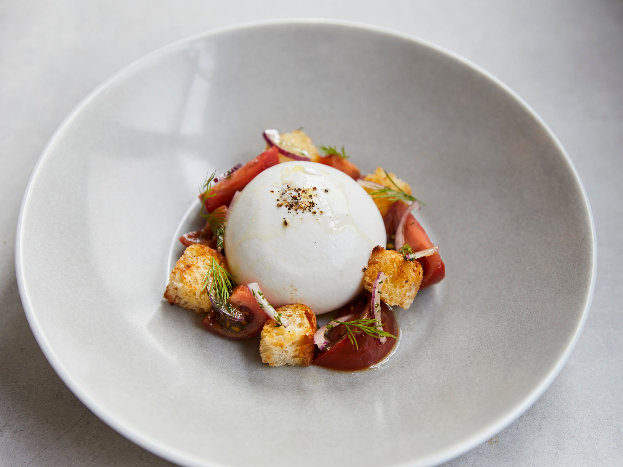 Combine two of your favourite things in this panzanella with burrata