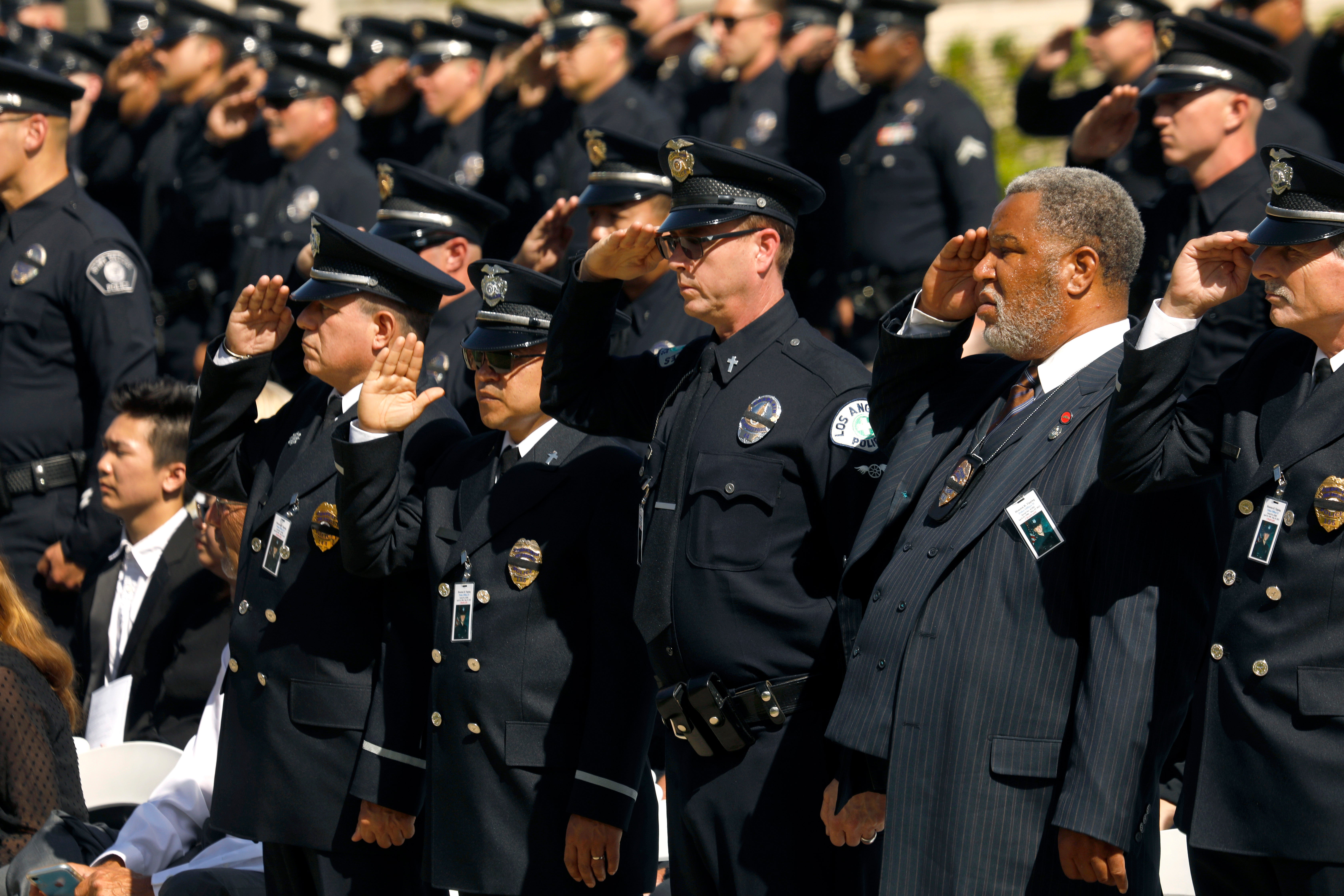 Family, friends, city officials and fellow officers salute fallen Los Angeles Police Officer Houston Tipping as they gather at Forest Lawn Hollywood Hills - Hall of Liberty Mosaic Deck for his funeral Wednesday, June 22, 2022, in Los Angeles