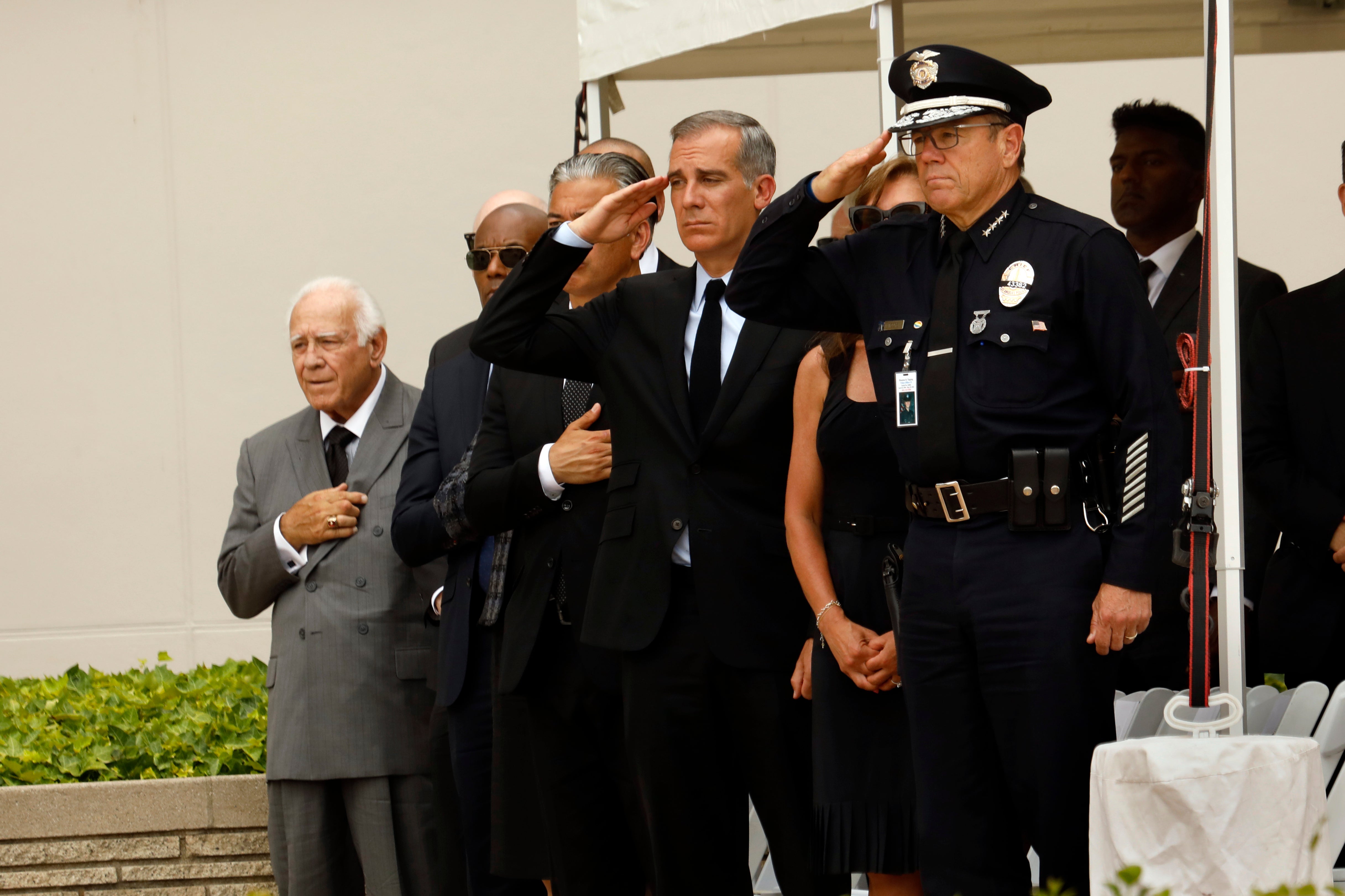 Family, friends, city officials and fellow officers salute fallen Los Angeles Police Officer Houston Tipping as they gather at Forest Lawn Hollywood Hills - Hall of Liberty Mosaic Deck for his funeral Wednesday, June 22, 2022, in Los Angeles