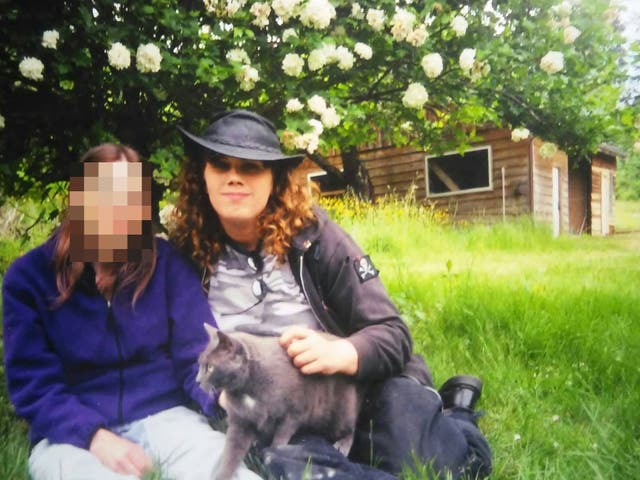 <p>Eilís Ní Fhlannagáin with her then girlfriend, outside the rural surgery clinic she set up and ran</p>